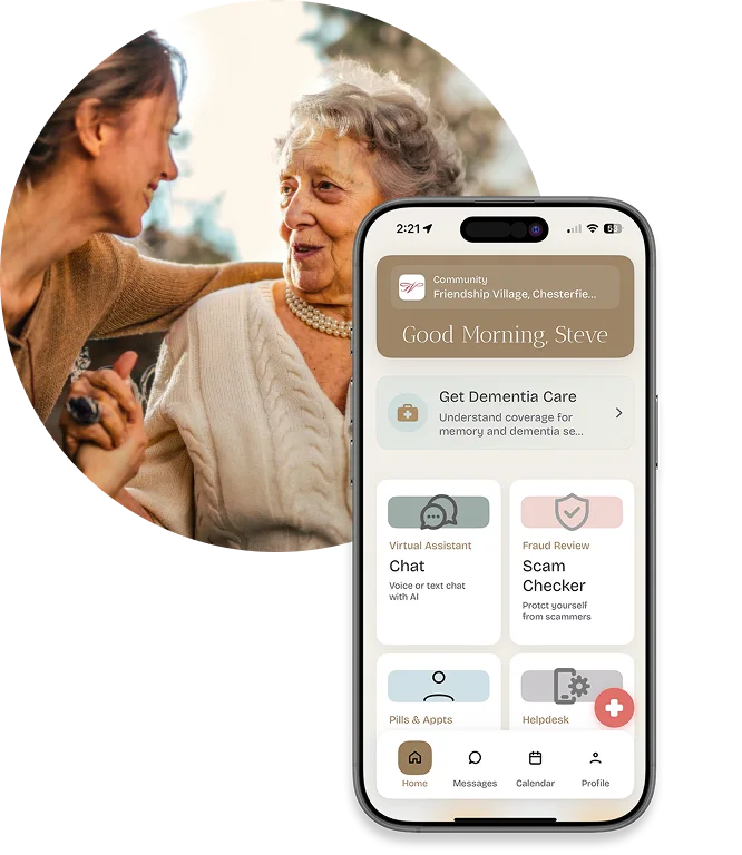 An elderly woman smiles while talking to a younger woman. In the foreground, a smartphone screen displays a dementia care app with options for a virtual assistant, scam checker, pills & appointments, and helpdesk.