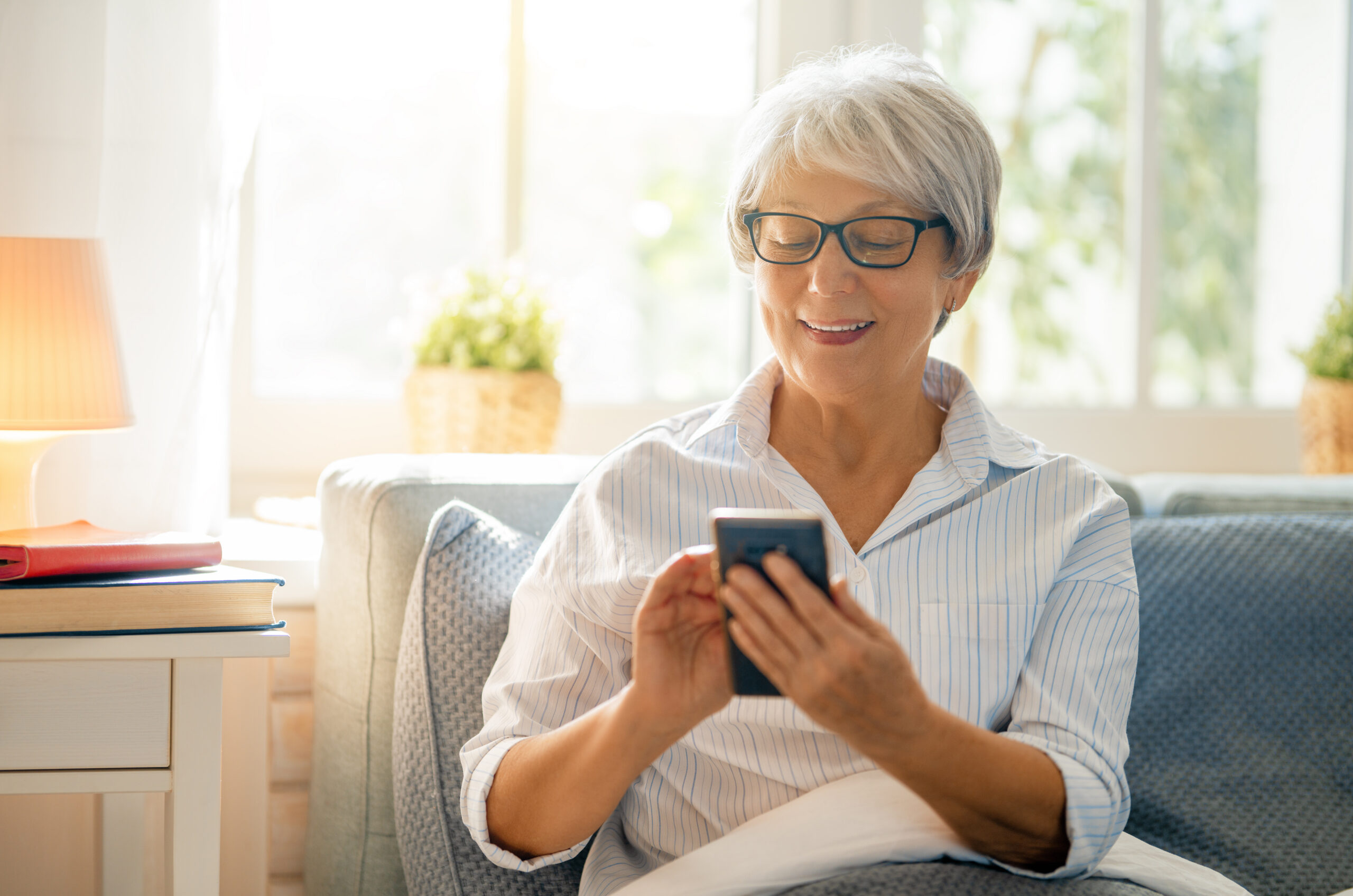 Senior reviewing medication management app on smartphone at home